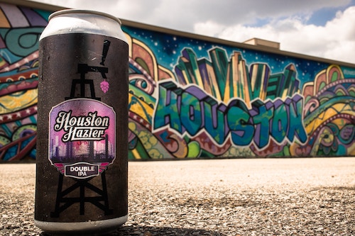 houston hazier ipa craft beer can in front of graffiti by josh olalde