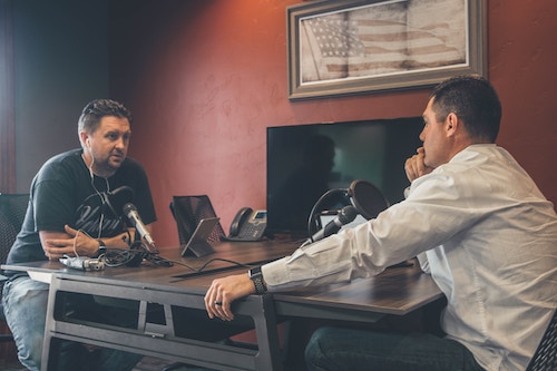 two-men-sitting-recording-a-podcast-for-business